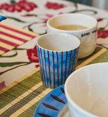 Anna + Nina Alfie Coffee Cup - on a table