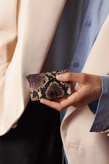 Secrid Serpent Purple Wallet - held by a model, in situ